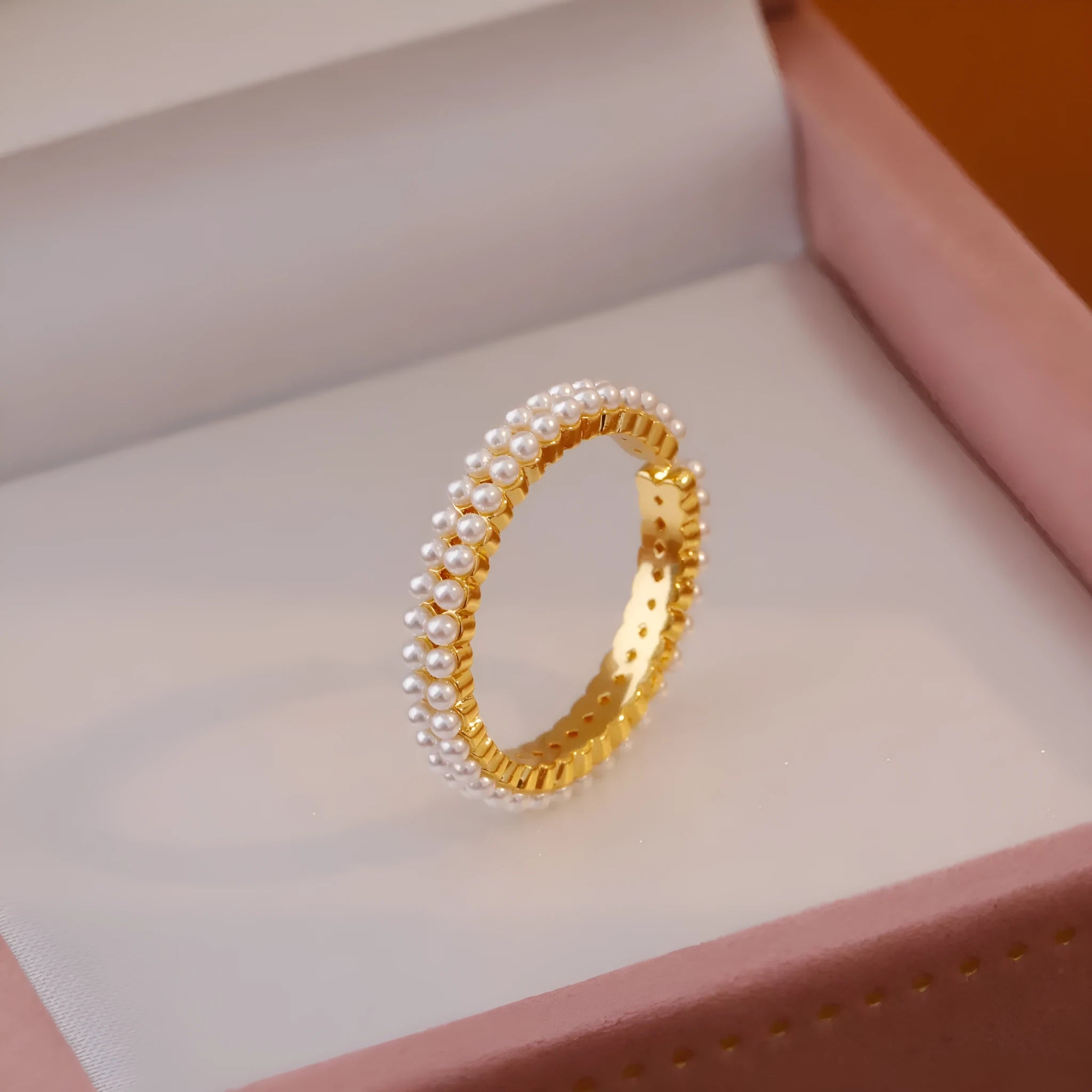 Gold geometric open mouth ring with round decorative elements on female hand