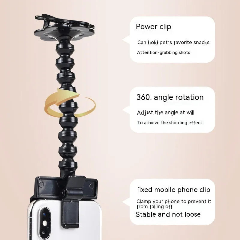Black pet photography tool holding a mobile phone and a dog treat, on a white background.
