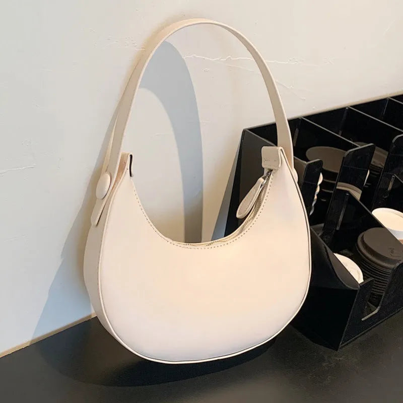 Women's retro dumpling shape shoulder bag in black with sandwich pocket and synthetic leather lining