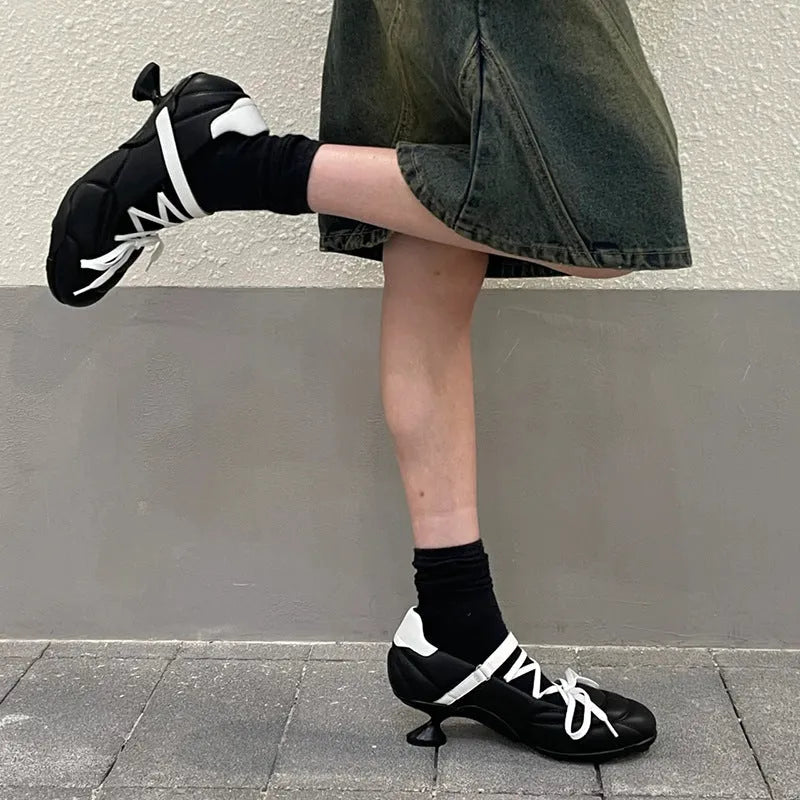 Women's silver lace-up sports shoes with a decorative bow on the front.