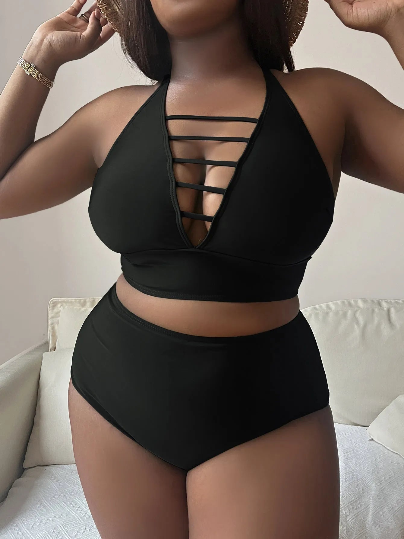 Plus size black halter bikini with cross back design and high waist briefs on mannequin