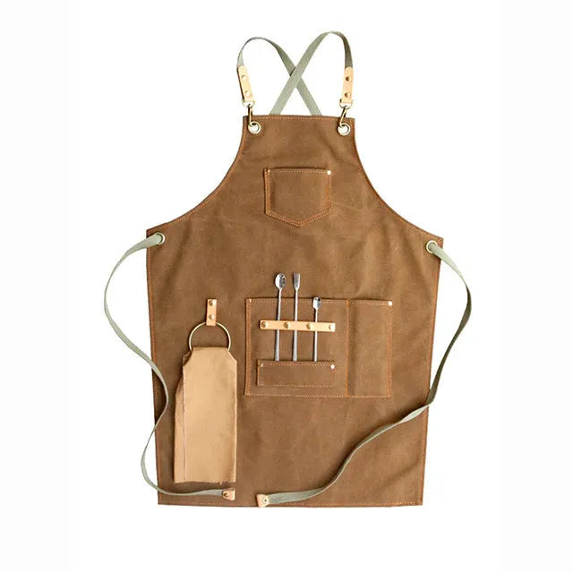 Canvas cross strap apron in camel colour shown from the front.
