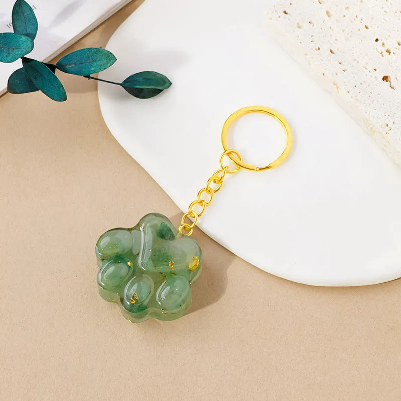 Natural crystal cat's paw keychain pendant in assorted gemstone colours on a keyring.