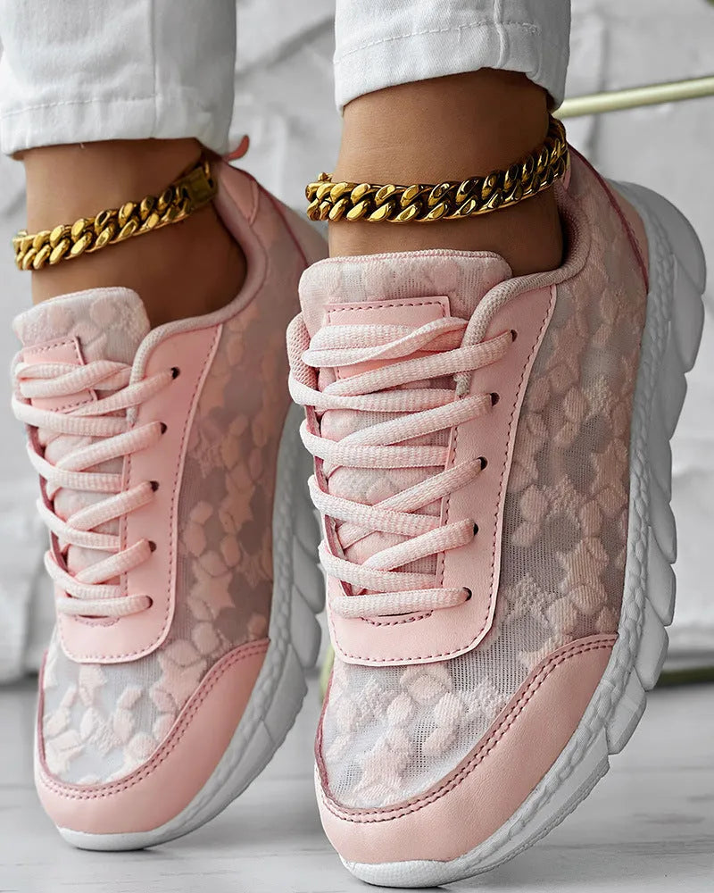 Women's white canvas casual running shoes with flat heel and round toe on a plain background.