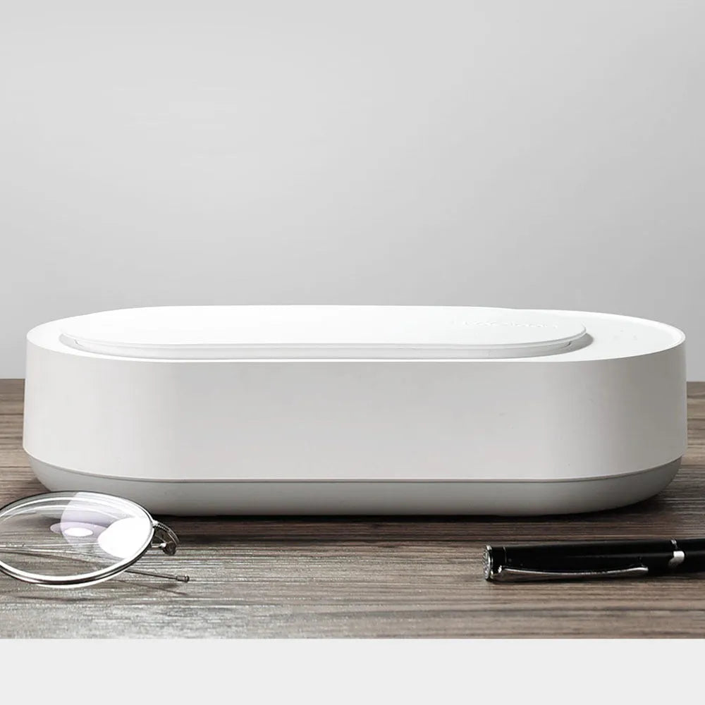 White portable ultrasonic cleaning machine with a stainless steel tank for jewellery and glasses.