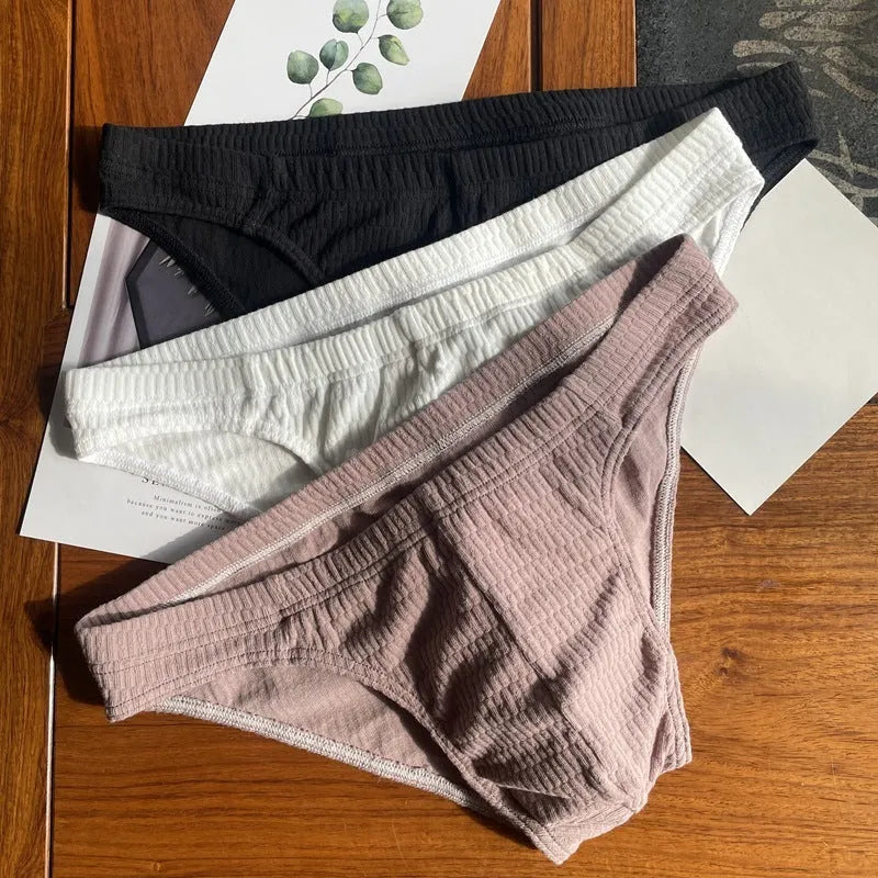 Men's solid colour pure cotton triangle briefs with a mid-waist body-shaping design.