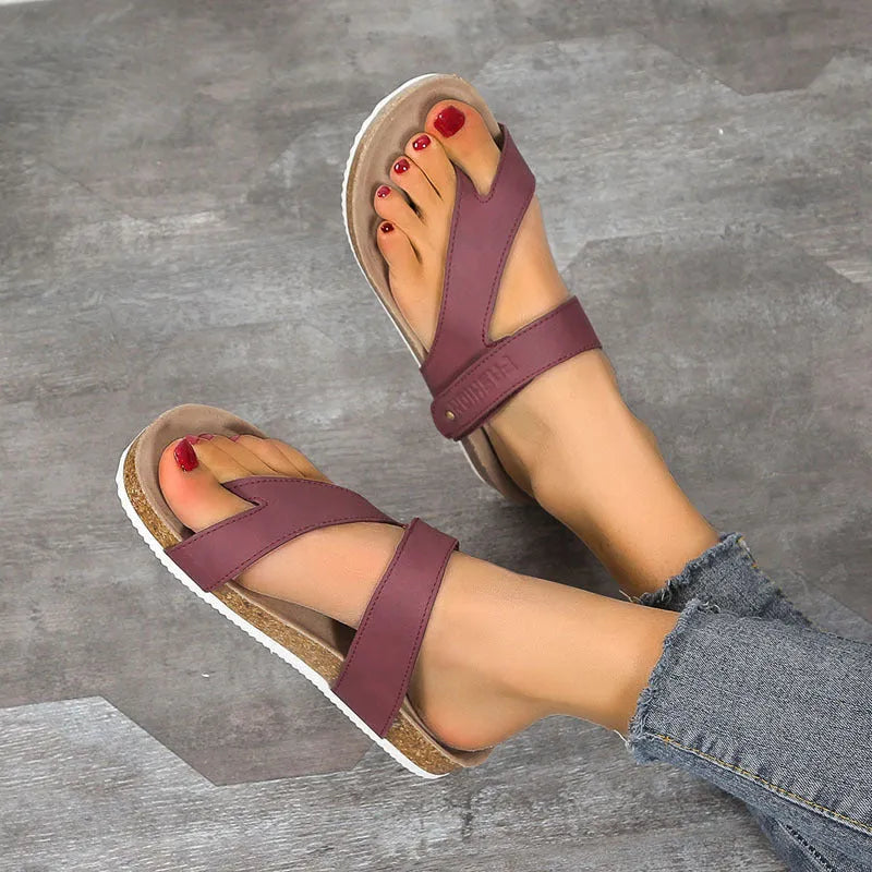 A pair of thick-soled flat toe ring flip-flops in a solid colour on a white background.
