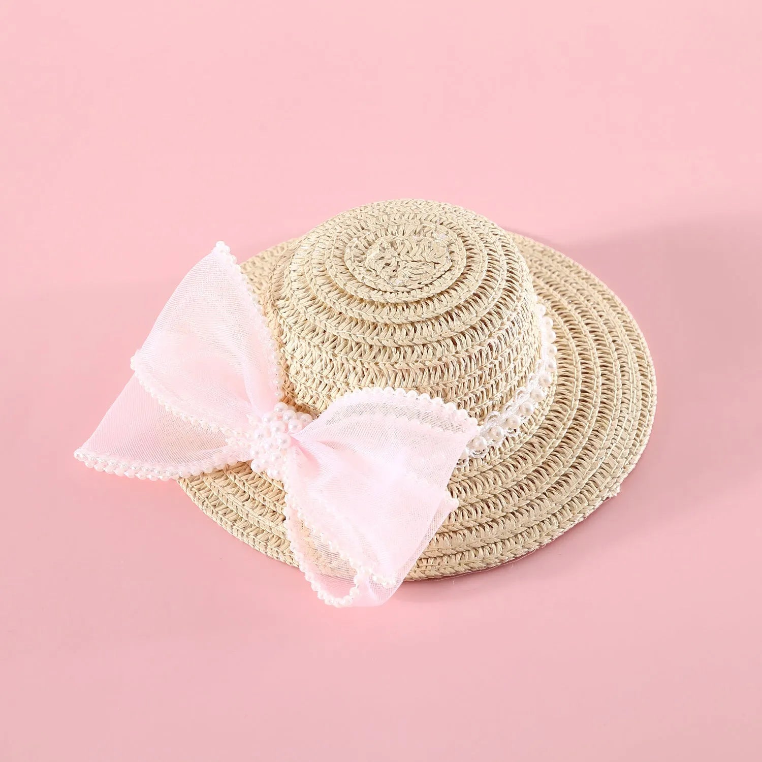 Pet cat wearing princess-style straw hat with woven pearl bow decoration in lafite leaves material