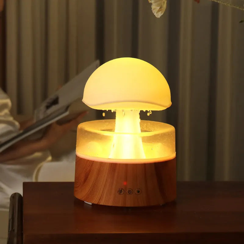 White cloud-shaped humidifier with falling raindrop effect and colour-changing LED lights