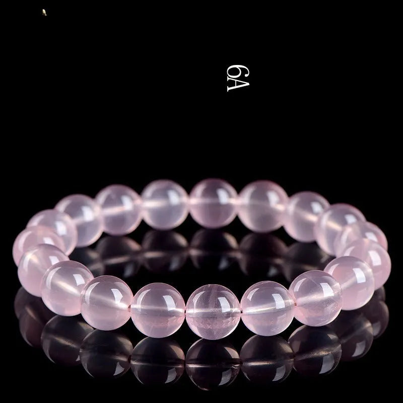 Natural starlight crystal bracelet with round polished pink beads in various size options.