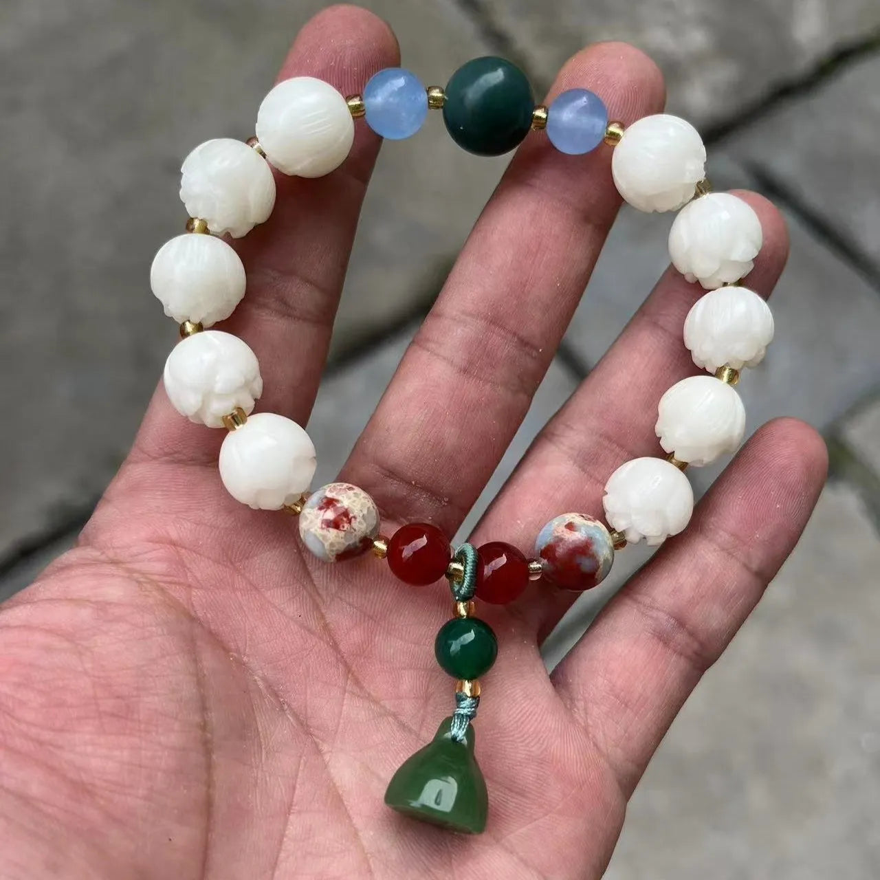 Carved pumpkin and lotus bead bracelet made from Bodhi root with white jade and aventurine details.