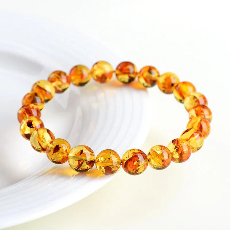 Natural yellow piebald amber bracelet with geometric beads on wrist
