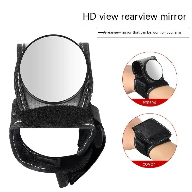 Black nylon wrist-mounted rear-view mirror for cyclists and motorcyclists on a textured background.