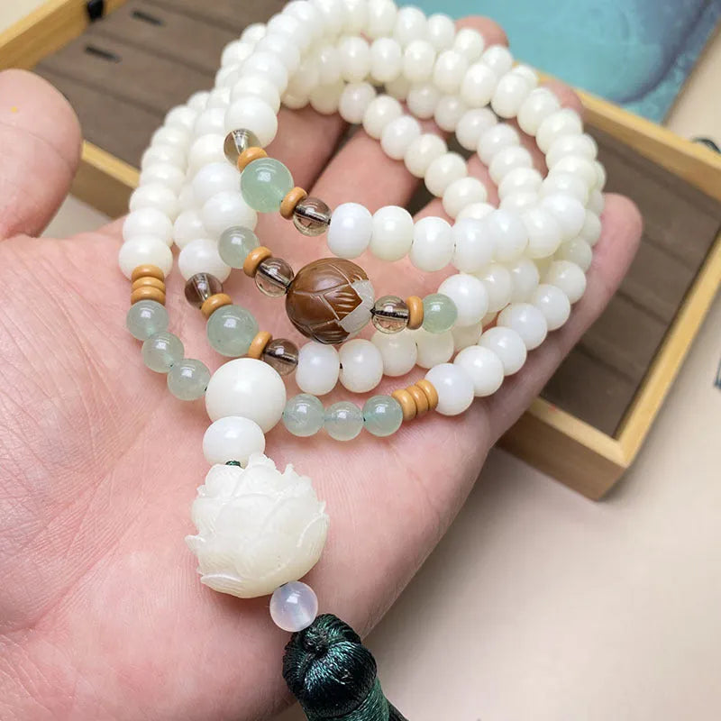 White jade bodhi 108-bead mala bracelet showing round beads in one of three pattern styles.