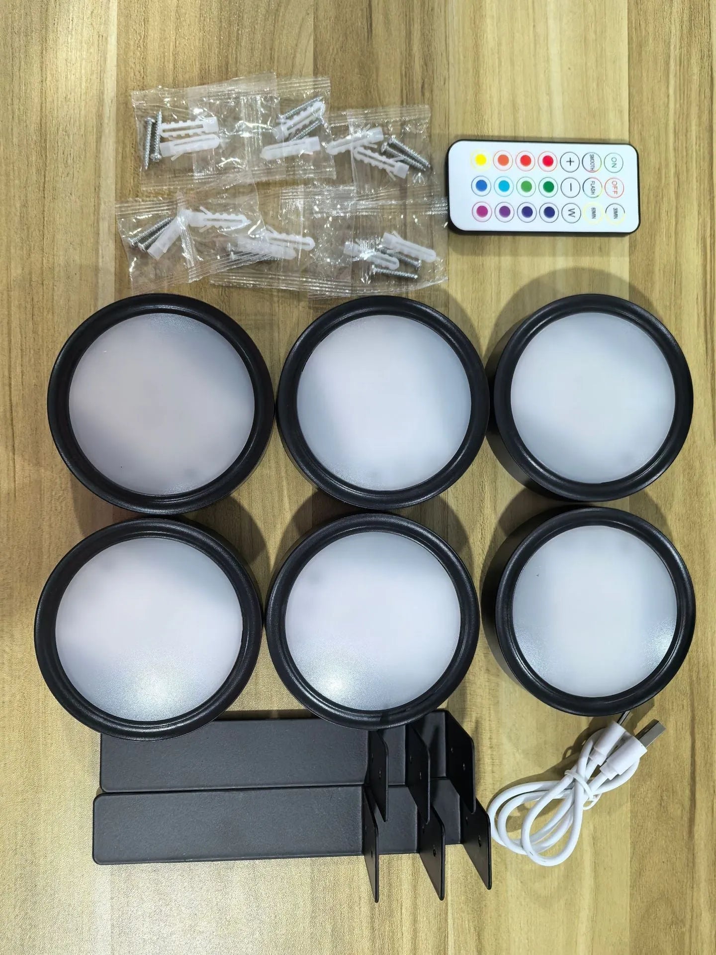 Wireless rechargeable LED painting lamp with magnetic belt attached to a metal frame, remote control nearby.