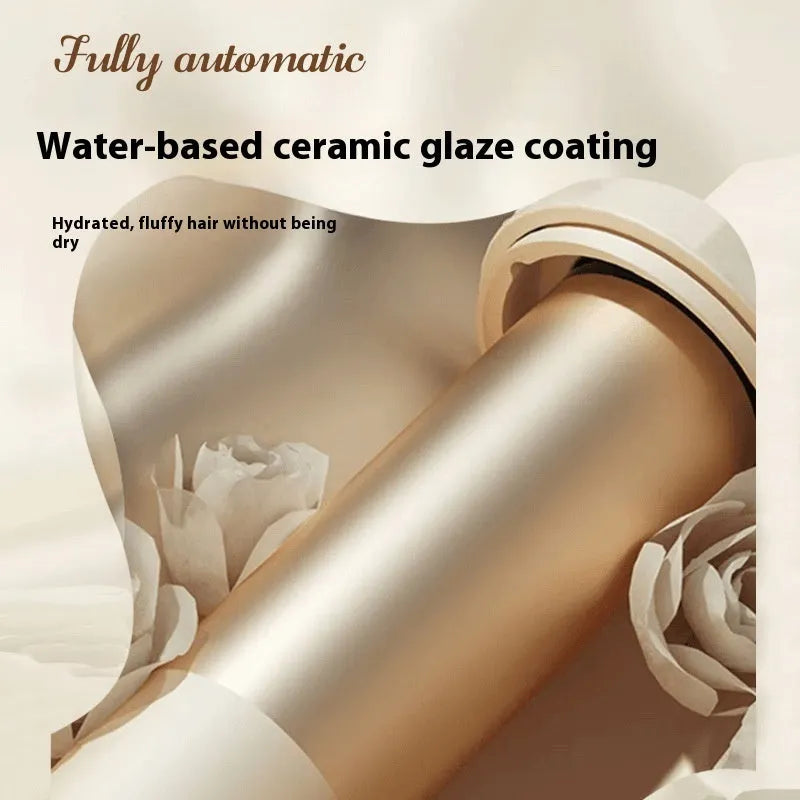 White automatic hair curler with 32mm ceramic barrel on a countertop.