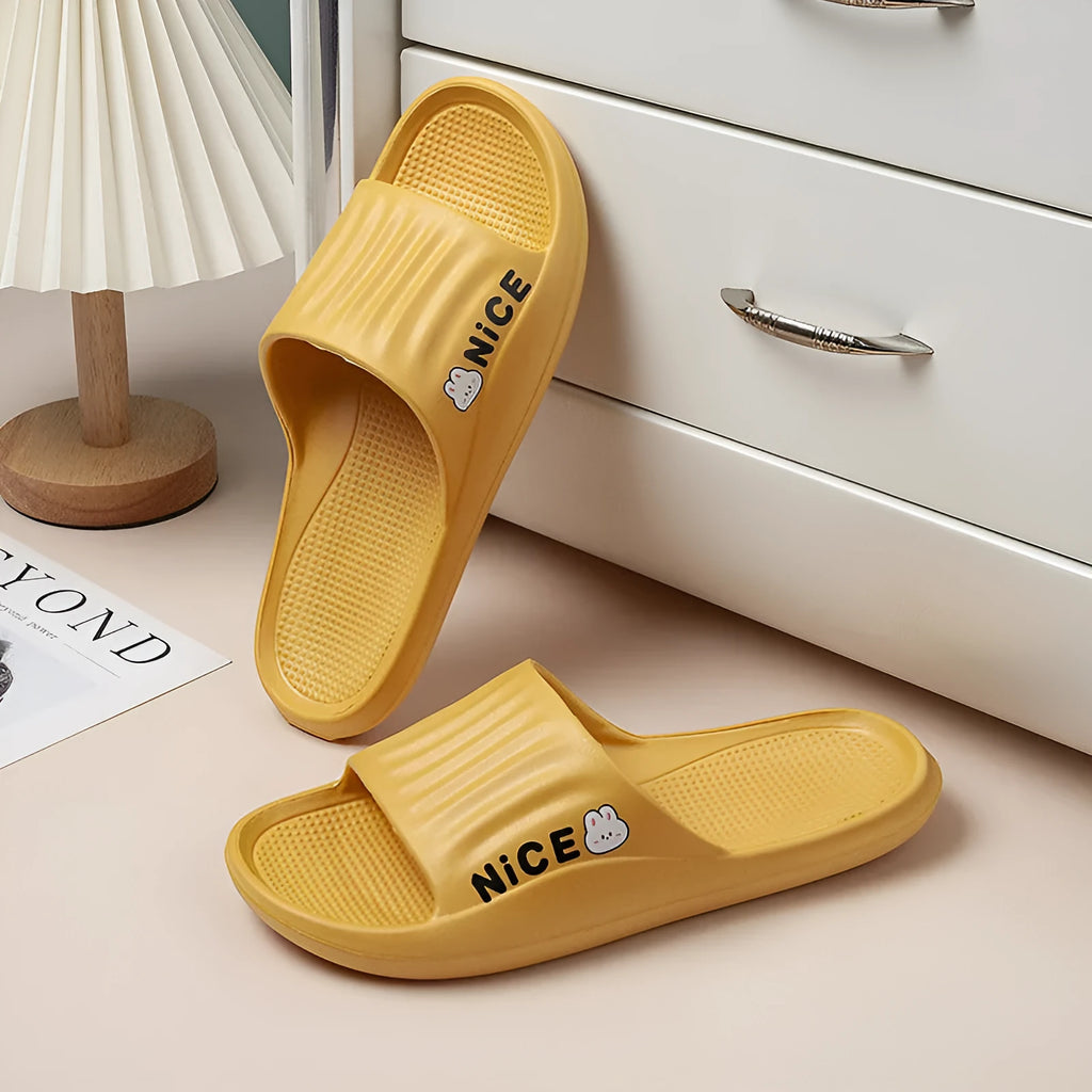 Adult unisex cartoon pattern EVA flip flop slippers in various colours on a white background.