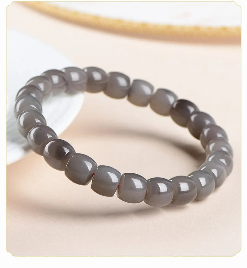Straight cut smokey violet Hetian jade bracelet with approximately 24 beads, each 8mm by 9mm.