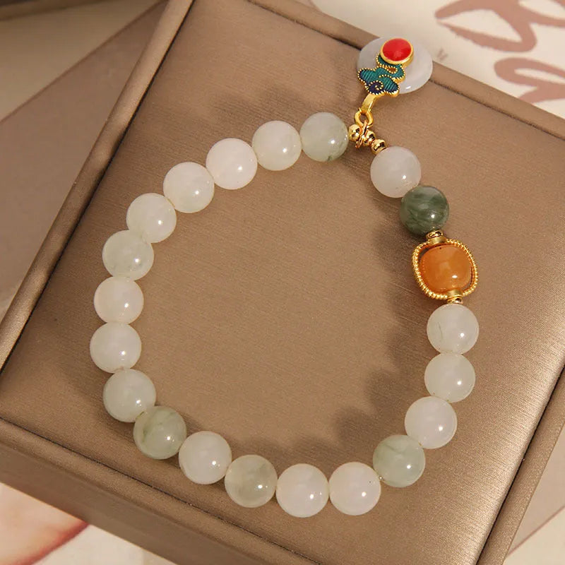 Women's genuine jade bracelet with an ice jade Xiangyun peace buckle and pearl decorative accents.