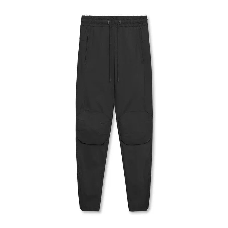 Men's grey loose-fit running pants with ankle ties on a gym floor