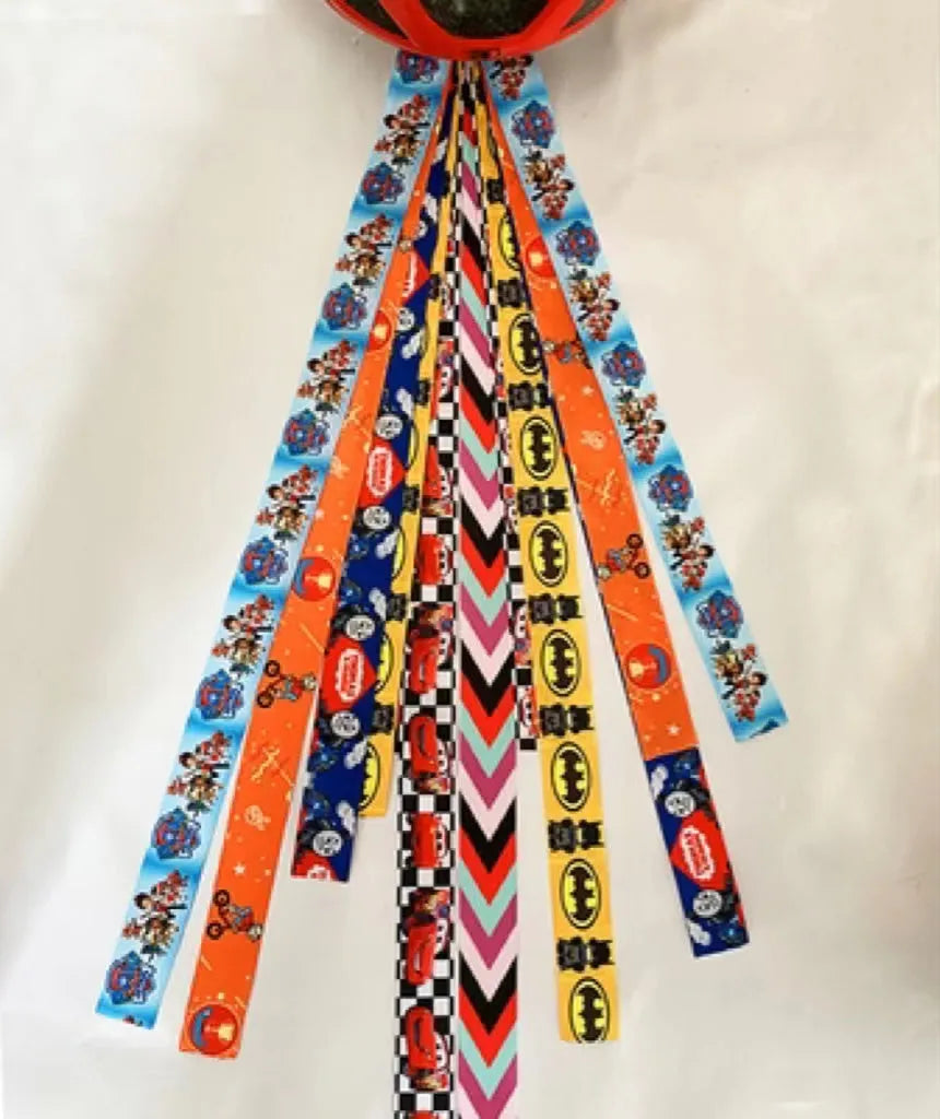 Colourful decorative ribbon streamers attached to a children safety helmet for skating or skiing