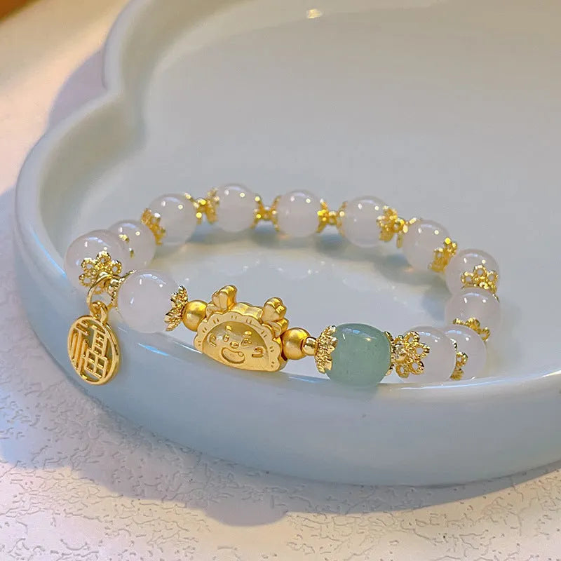 Women's floral glazed glass bracelet with animal zodiac charms in red, pink and white bead colour variations