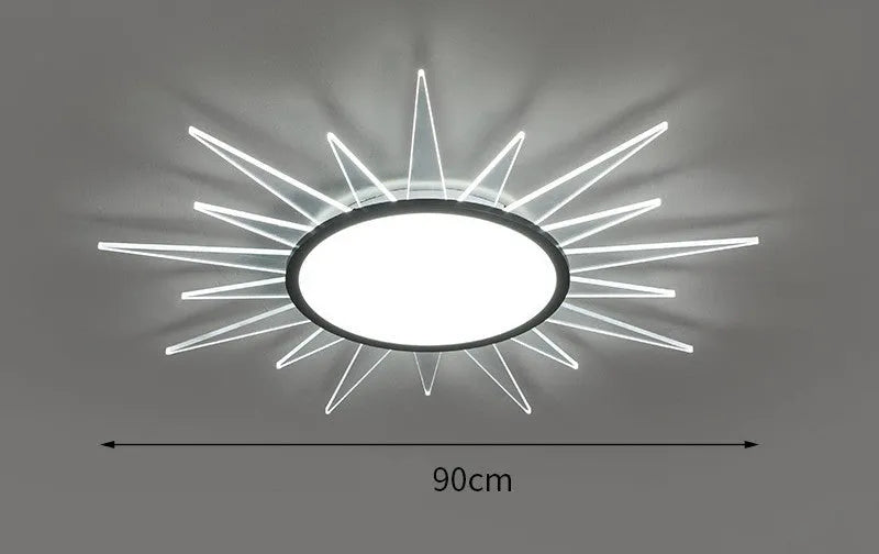 Modern round aluminium LED ceiling lamp with remote control on a white ceiling.