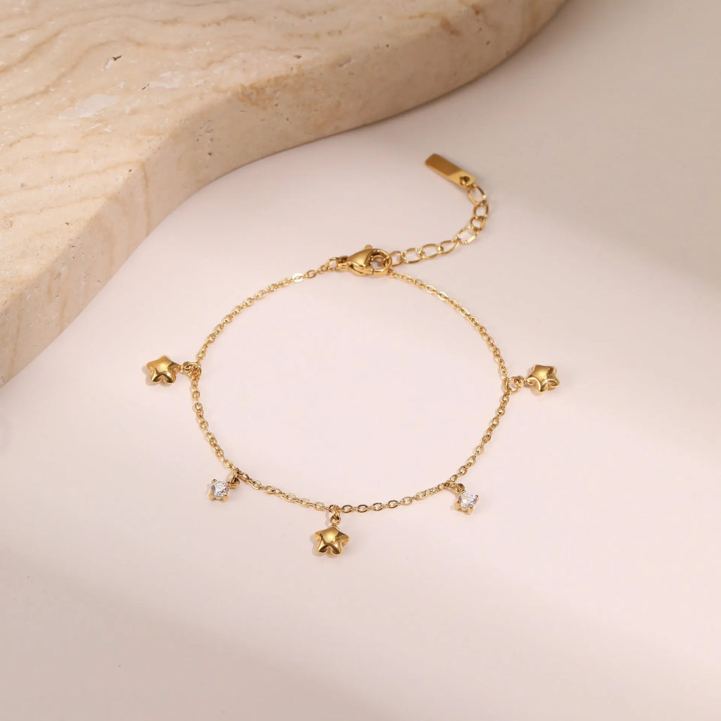 Women's gold-plated bracelet with a geometric zircon star pendant on a stainless steel chain.