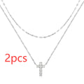 S925 sterling silver double layer twin diamond cross pendant necklace on a clavicle chain, shown in gold and white gold colour finishes.