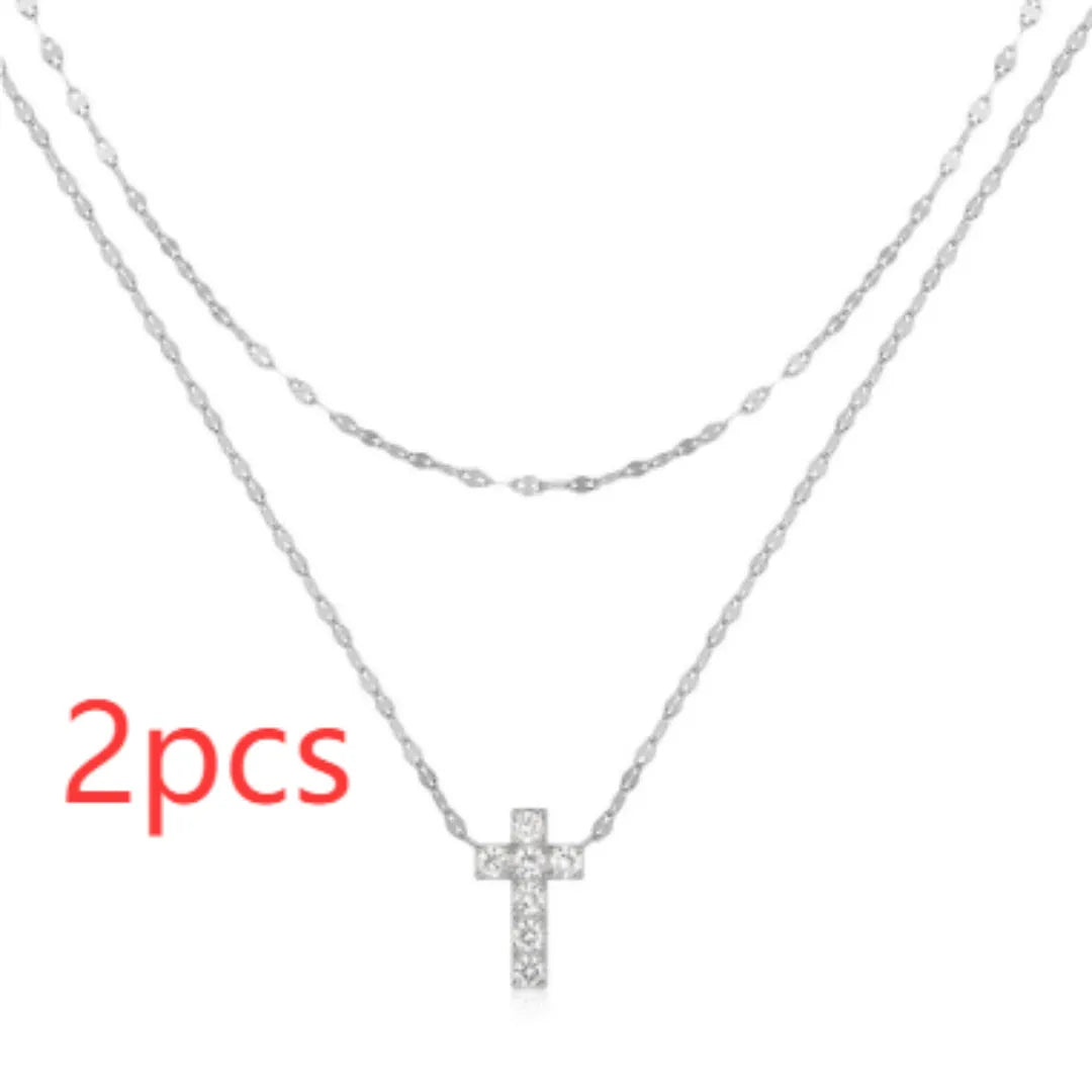 S925 sterling silver double layer twin diamond cross pendant necklace on a clavicle chain, shown in gold and white gold colour finishes.