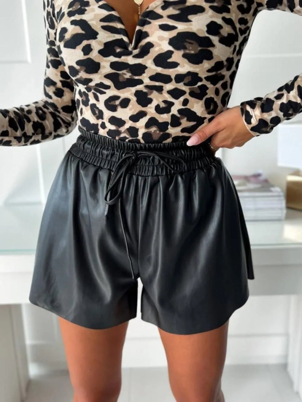 Women's black and khaki wide leg shorts with PU leather panels and lace up detailing, mid-waist drawstring closure