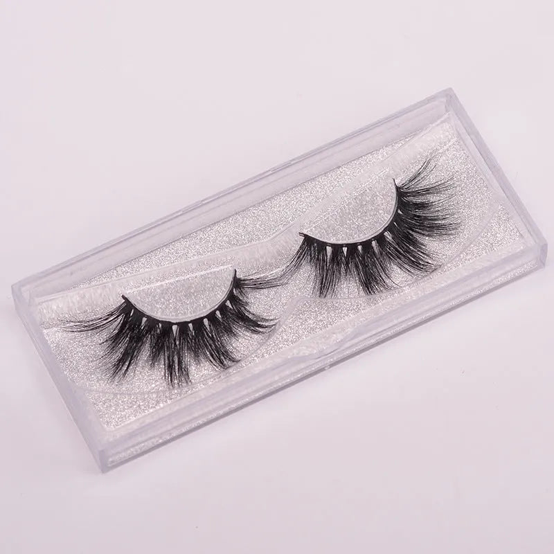 A pair of 5D volume false eyelashes made from real mink hair, with an application brush and storage case.