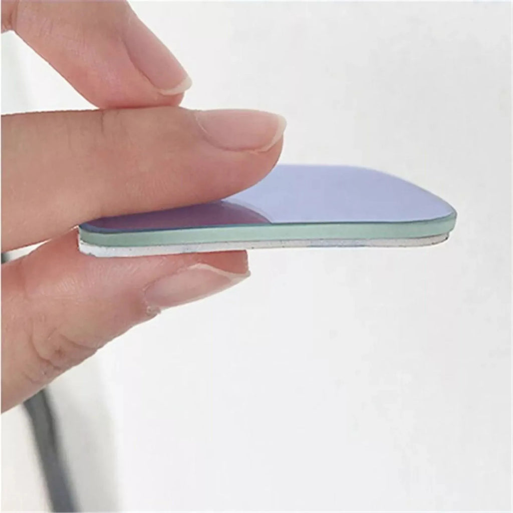A pair of small, fan-shaped white glass blind spot mirrors for cars, showing 360-degree adjustable mounting.