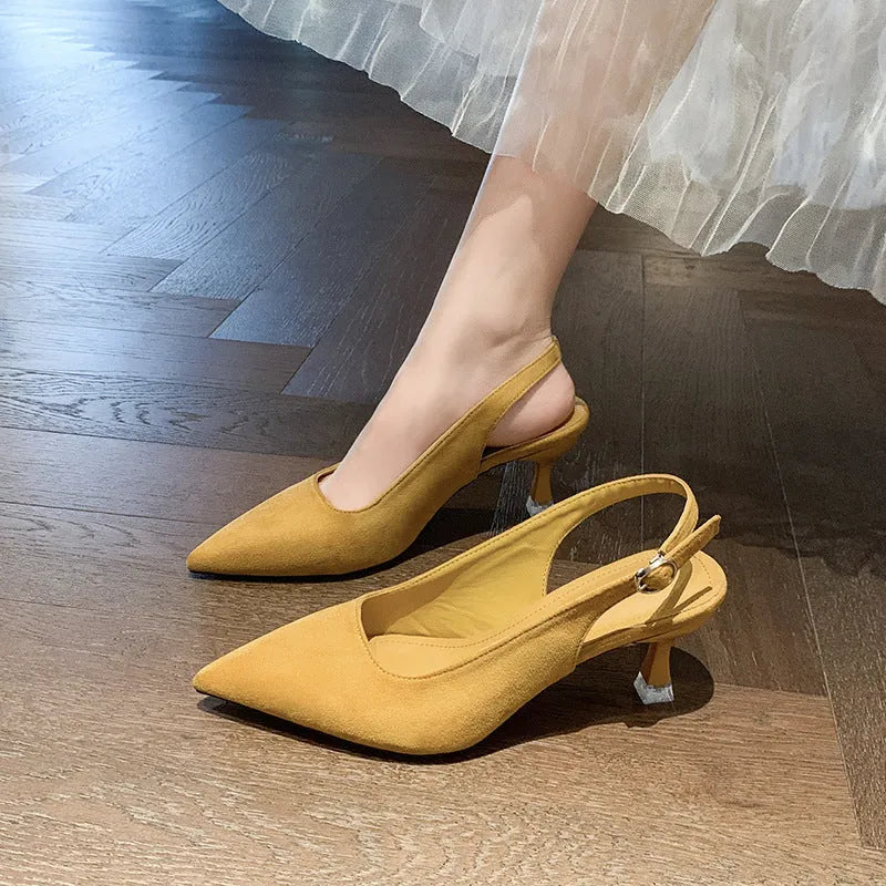 Apricot suede stiletto high heels with a pointed toe and rubber sole on a plain background.