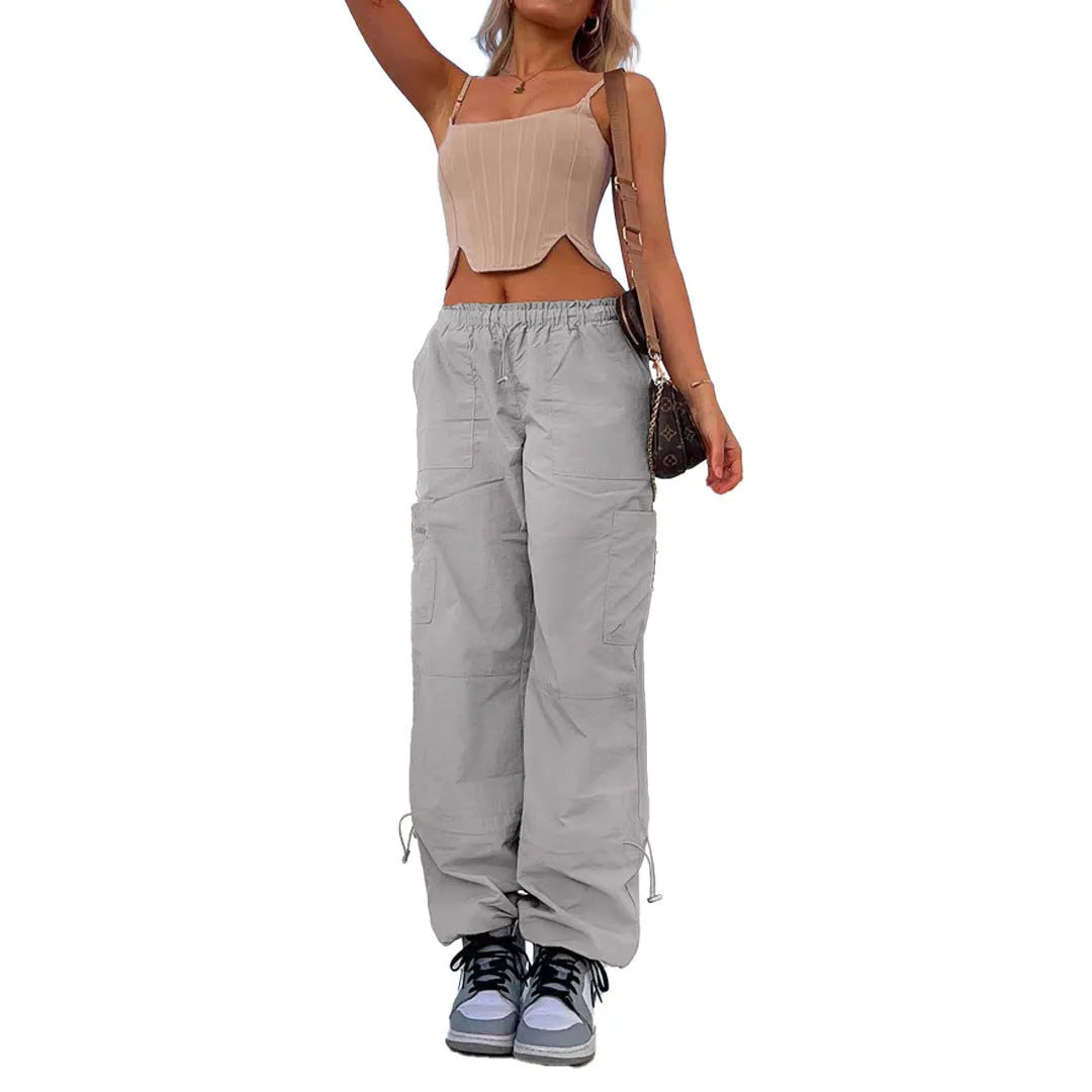 Man wearing loose grey straight-leg cargo casual pants with multiple pockets.