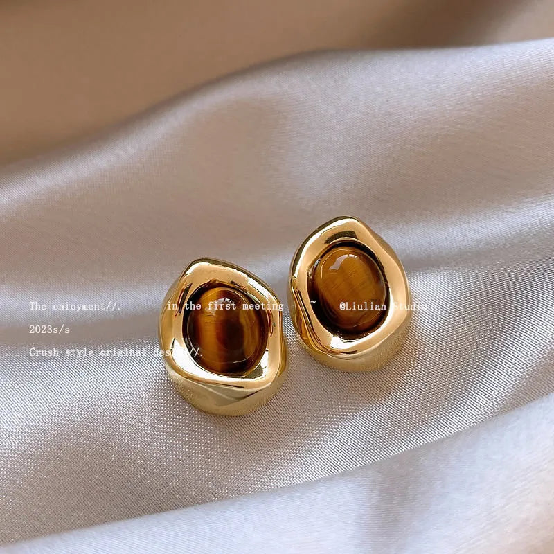 Three pairs of handmade geometric ear studs with electroplated alloy construction and tassel detailing in different colour treatments