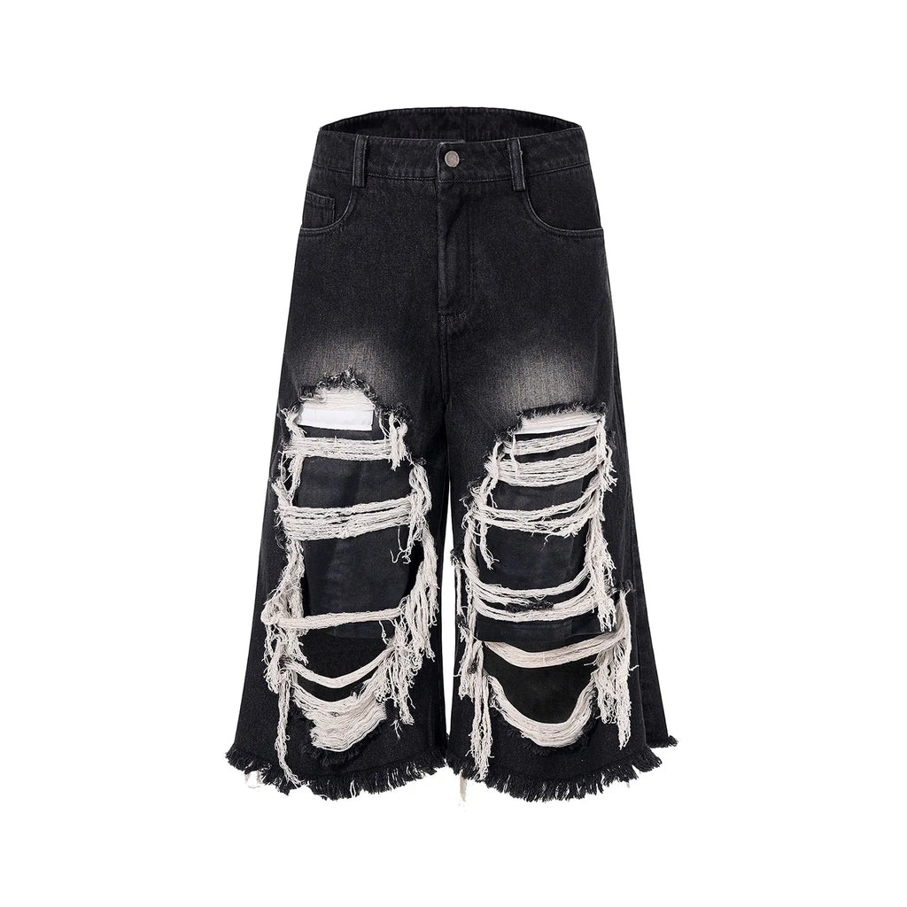 Black women's wide-leg cropped jeans with ripped patch details on the legs.
