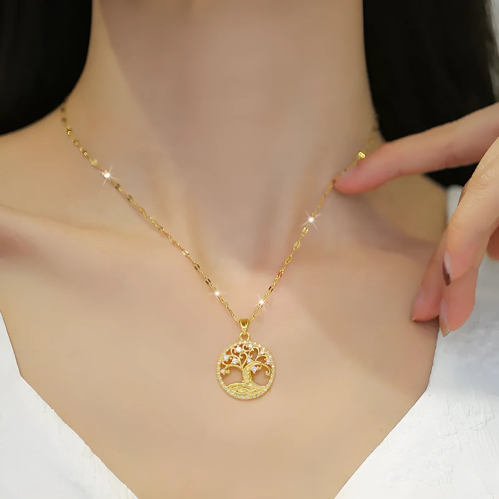 Gold-plated necklace with mother of pearl lucky tree pendant and rhinestone zircons on an adjustable chain.
