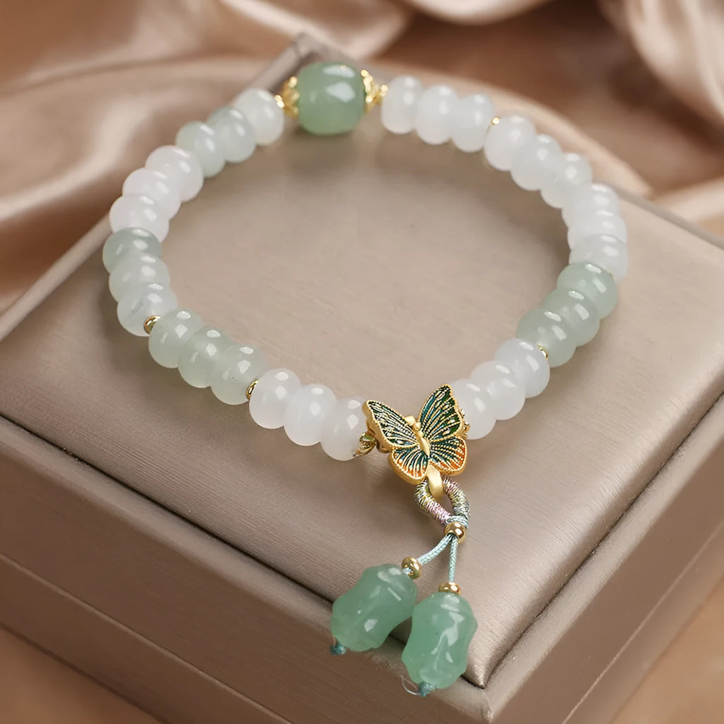 Green crystal Tian Shan Cui abacus bead bracelet with butterfly tassel, pearls and rhinestones.