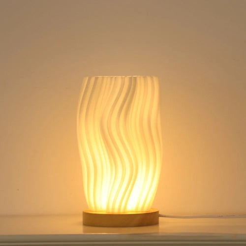 3D printed cylindrical vase night lamp in wood colour finish on a modern bedside table
