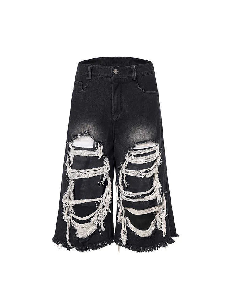 Black women's wide-leg cropped jeans with ripped patch details on the legs.