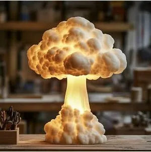 Mushroom cloud shaped atomic explosion table lamp with USB power cable on a desk.
