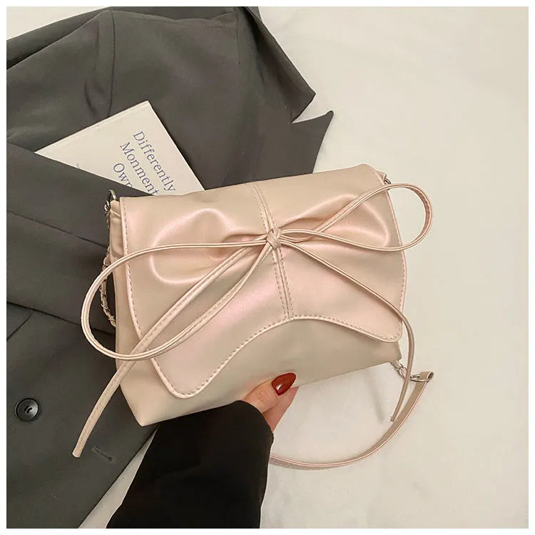 Women's black PU leather crossbody bag with horizontal square shape and visible sewing details