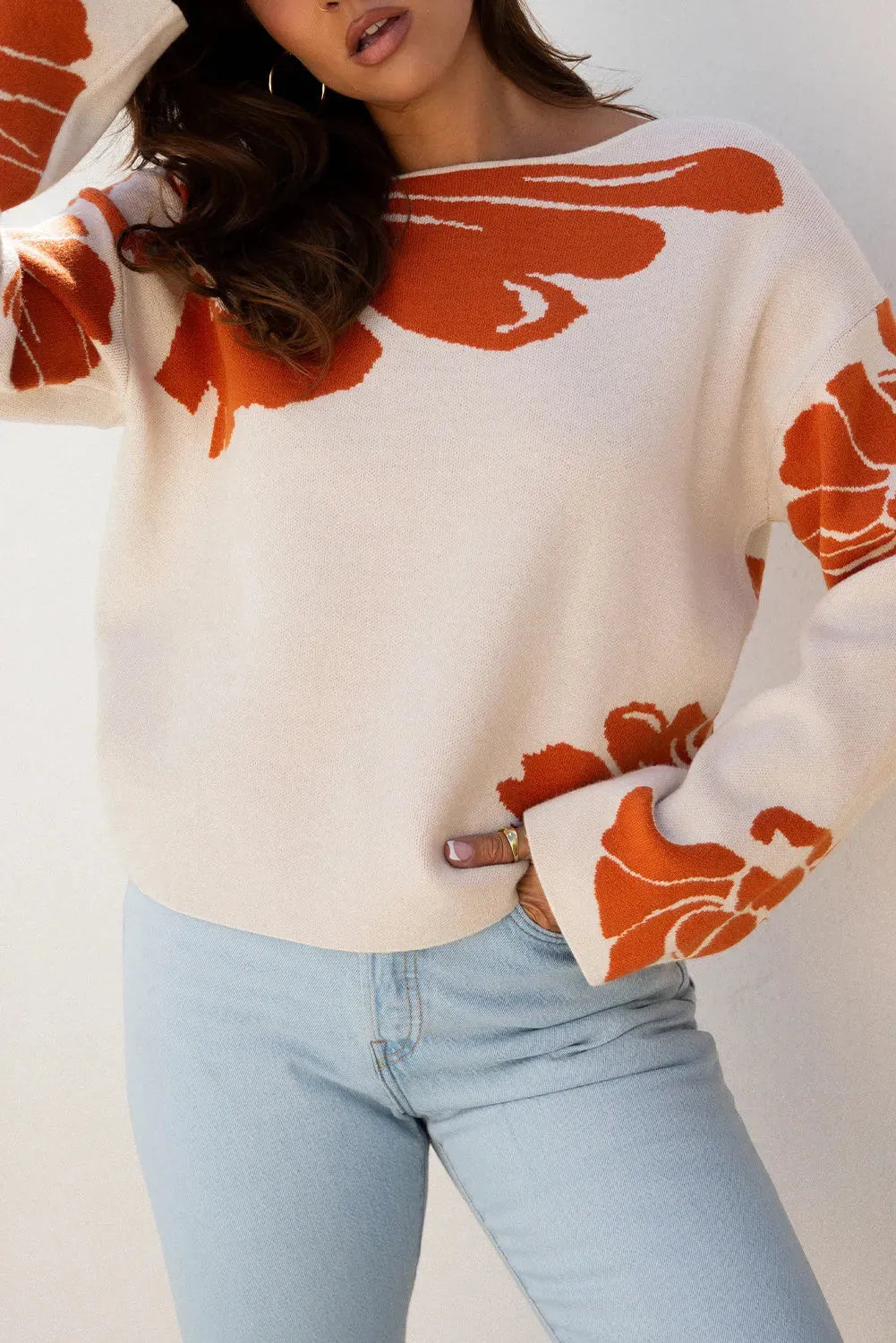 Beige bold flower pattern wide sleeve baggy sweater on display showing loose fit and floral print