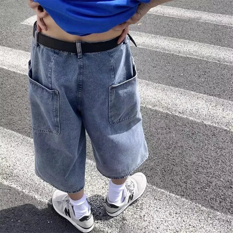 Men's washed blue denim pirate shorts with high waist and cropped straight legs on a plain background