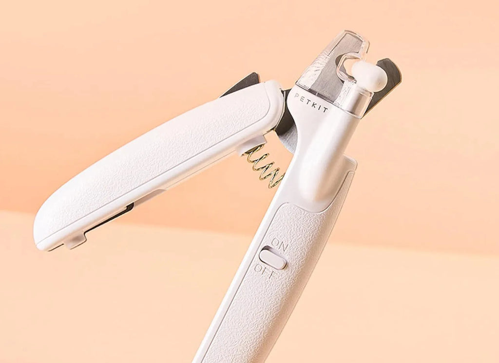 White pet nail clippers with LED light, transparent guard, and nail file for cats and dogs