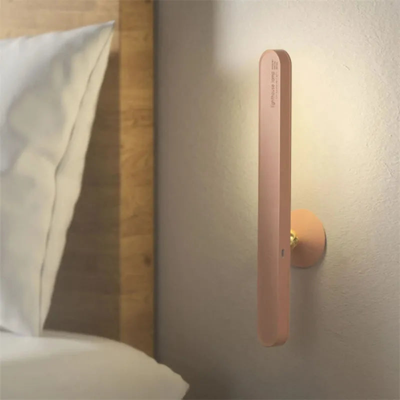 White geometric table lamp with touch switch and USB cable on a wooden desk.