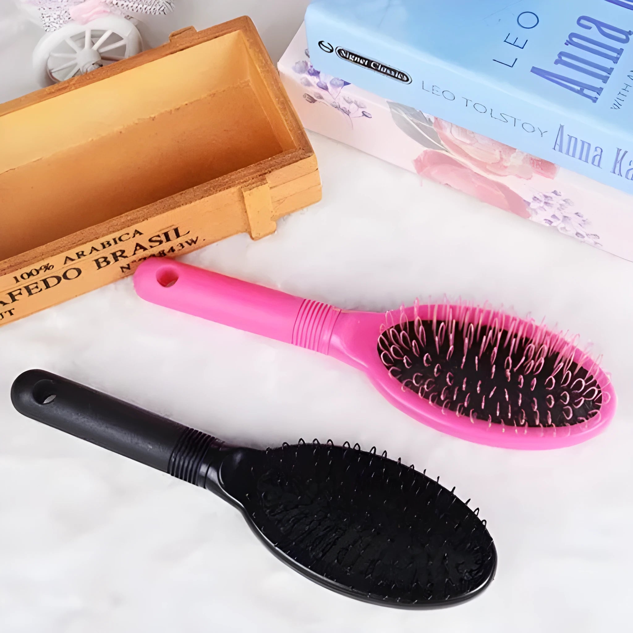 Black ring tooth plastic comb with airbag feature for hair extensions, shown next to a pink version.