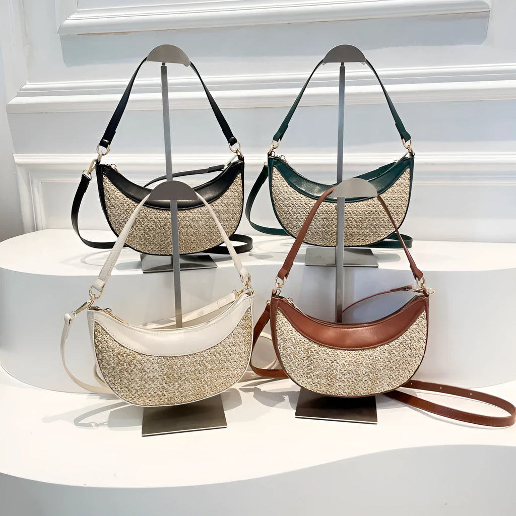 Straw crossbody dumpling bag in a hard suitcase shape with a single shoulder strap.