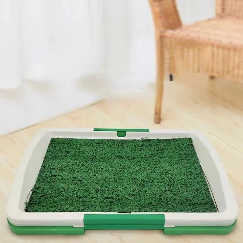Green synthetic grass dog toilet training tray with plastic base and absorbent pad layer.